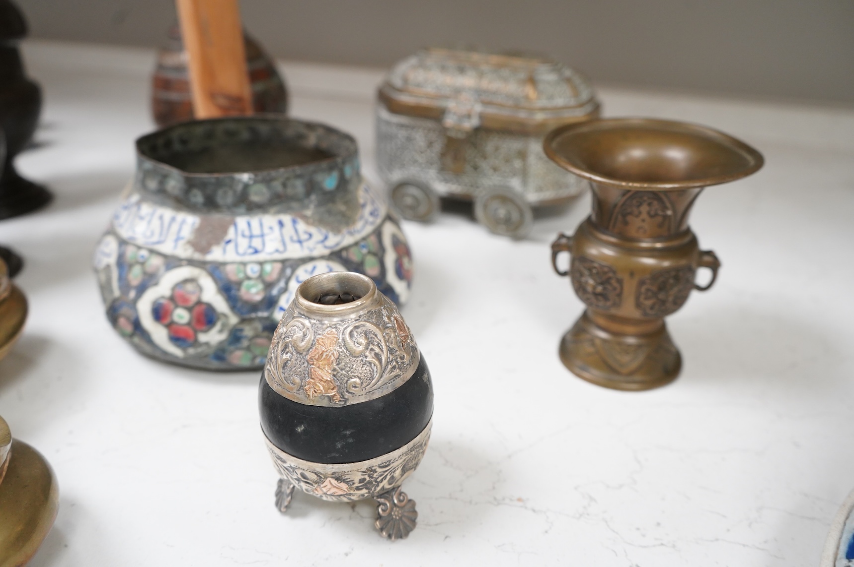 A collection of Persian, Eastern and Chinese metalware to include two brass tripod censers, pair of vases and an enamel bowl, largest 33cm high